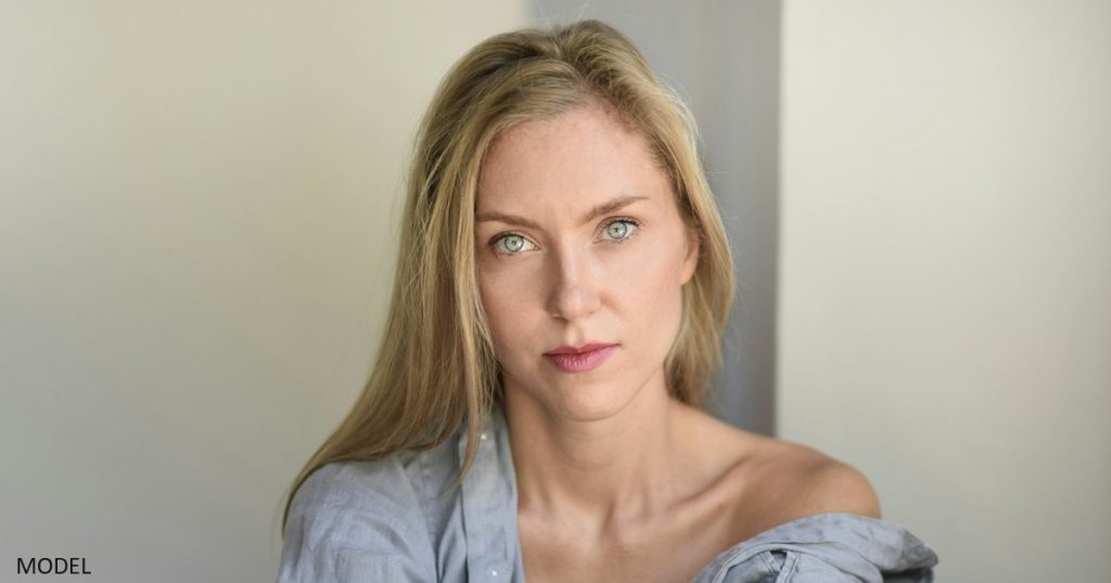 Woman looking into camera with serious expression on her face