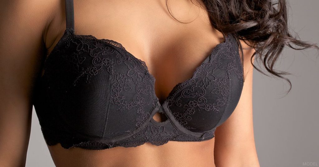 Close up of a woman's breast in black bra. (Model)