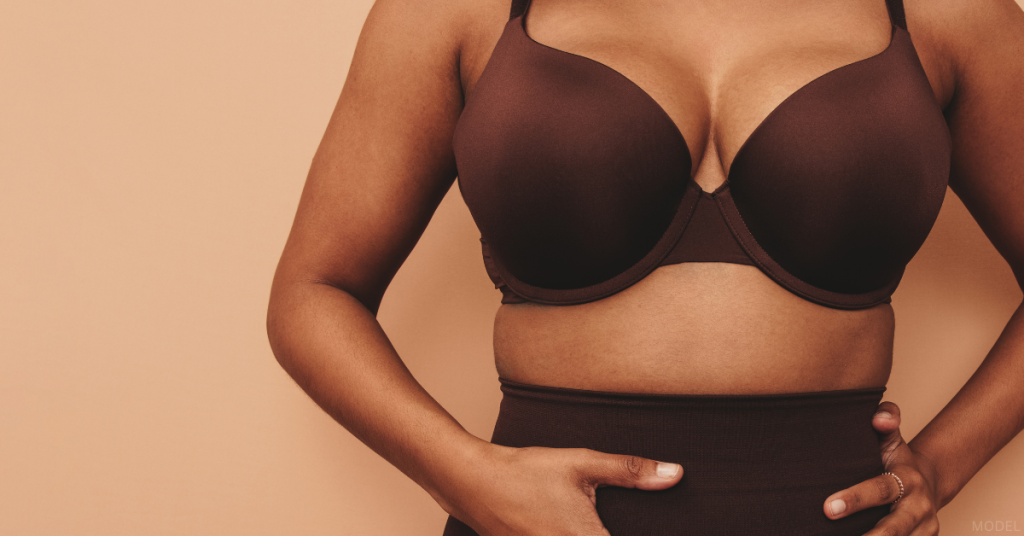 Woman wearing a bra with her hands on her waist (model)